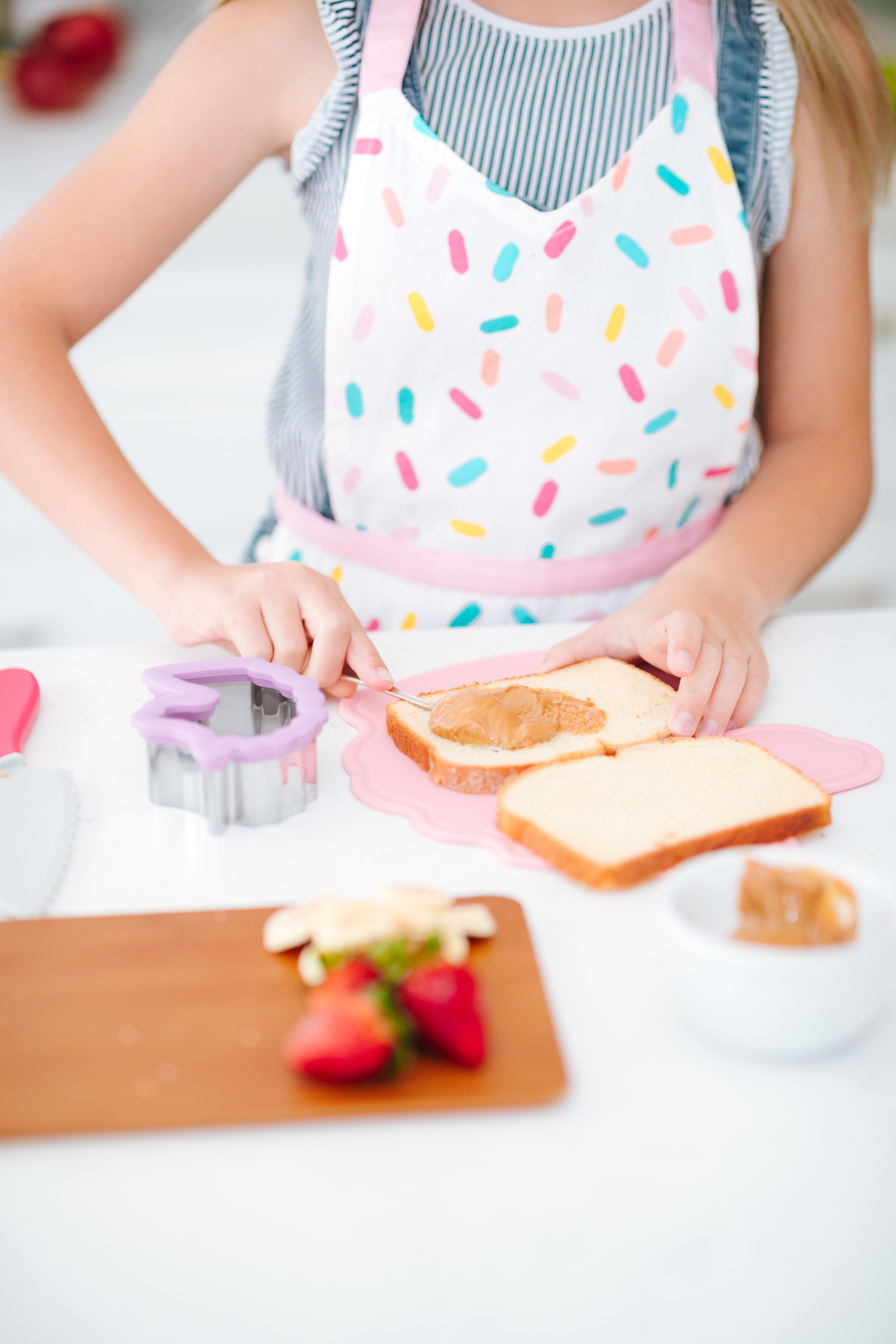 Lifestyle image of a girl making a sandwich