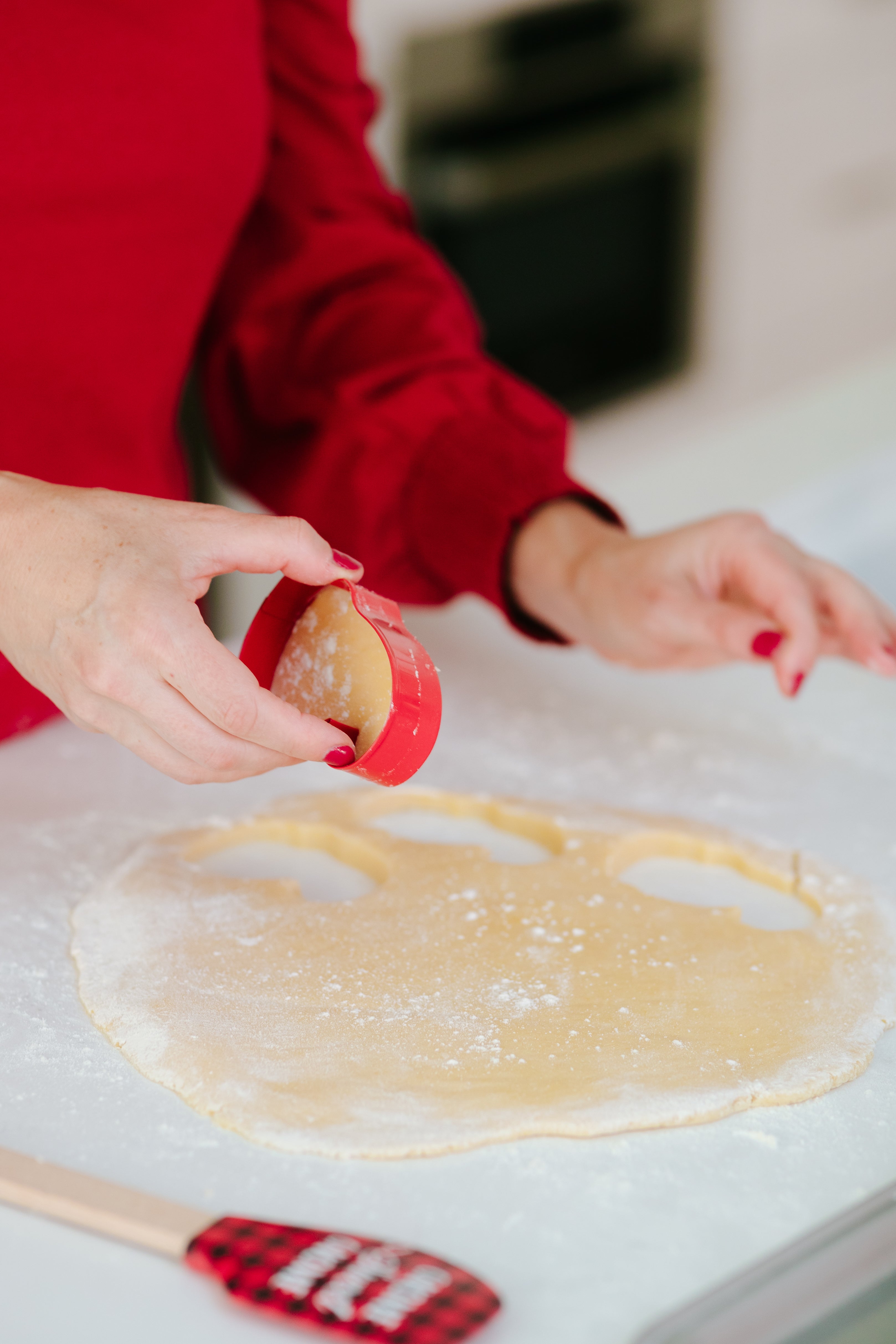 Lifestyle image of a person cutting out gnome cookies 