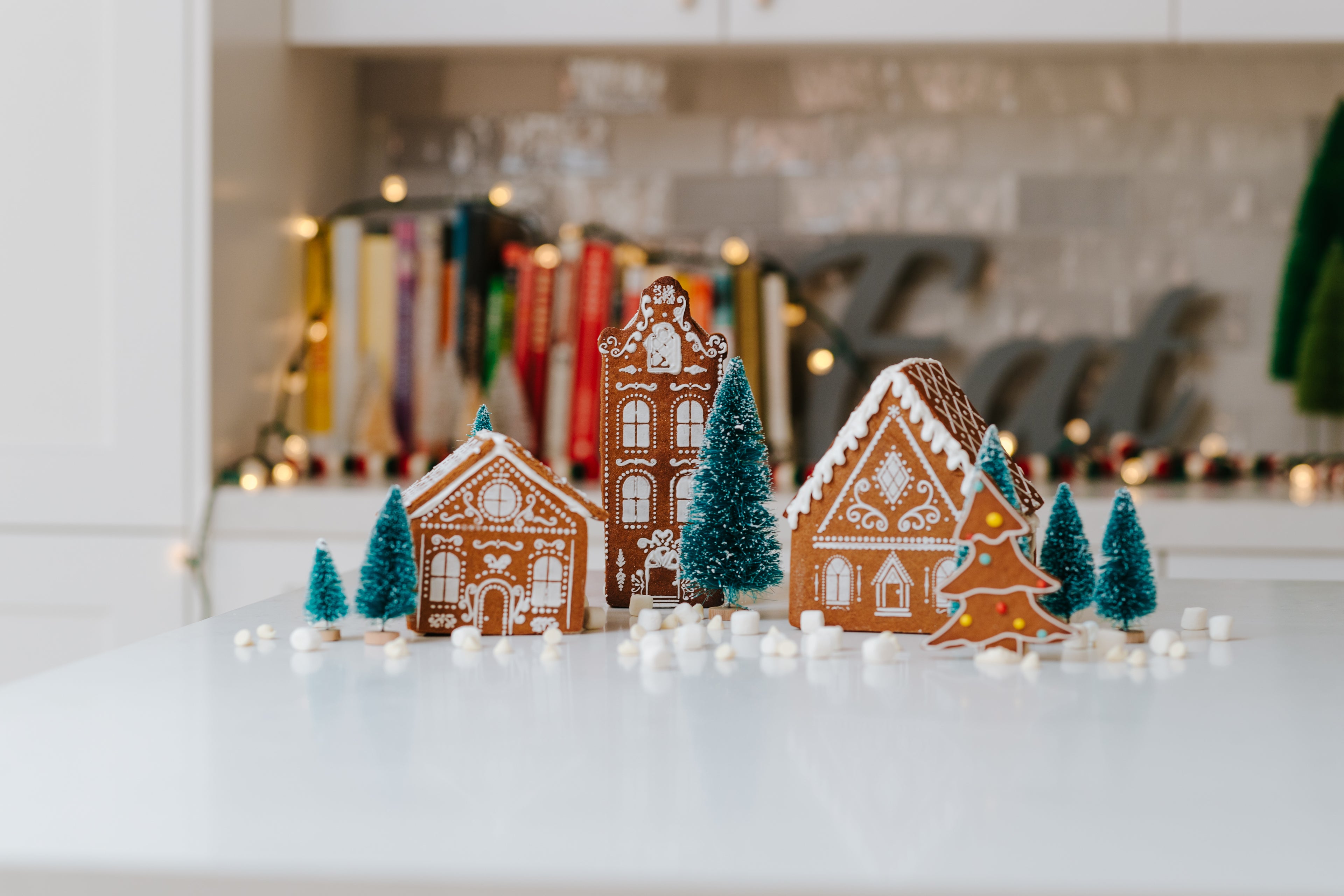 Fully decorated gingerbread village displayed with Christmas trees and marshmellows