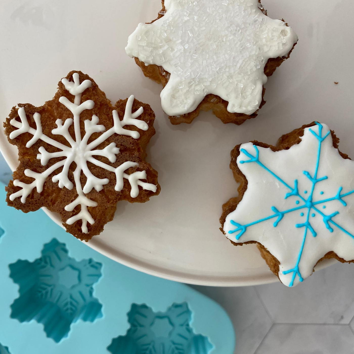 Lifestyle image of 3 decorated snowflake cupcakes