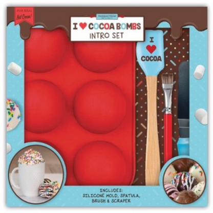 In box image of I ❤️ Cocoa Bombs Intro Set containing : 1 silicone mold to make 3 cocoa bombs, 1 spatula, 1 brush and 1 chocolate scraper, plus QR code link to exclusive recipes and videos.