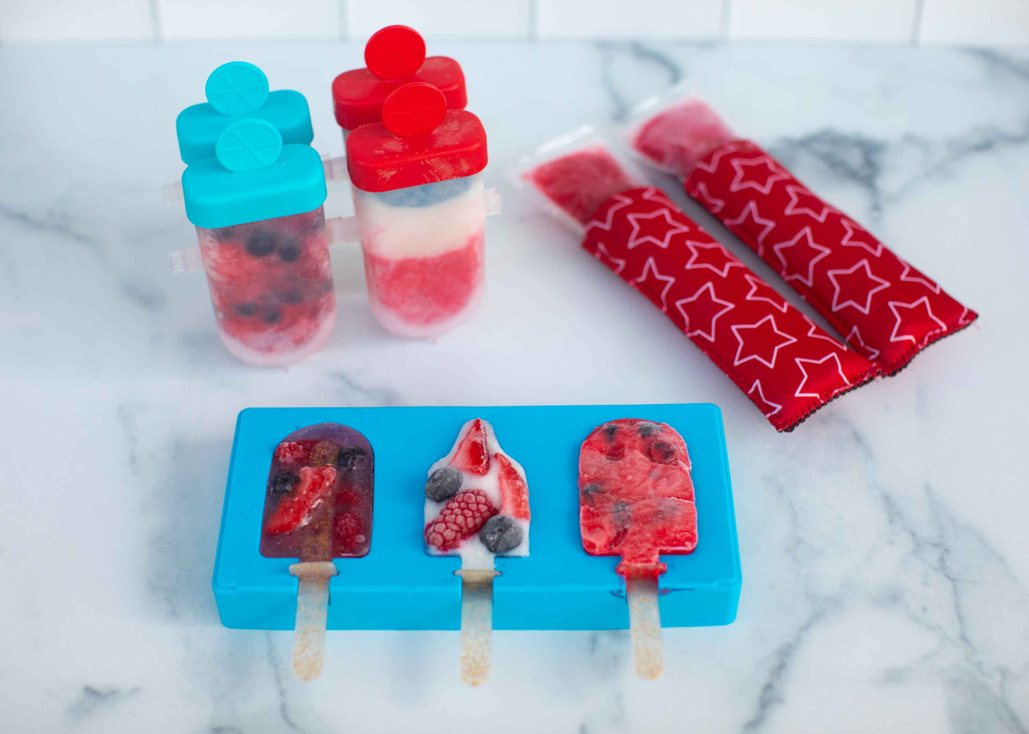 Lifestyle image of berry flavored popsicles  using all of the ice pop party molds