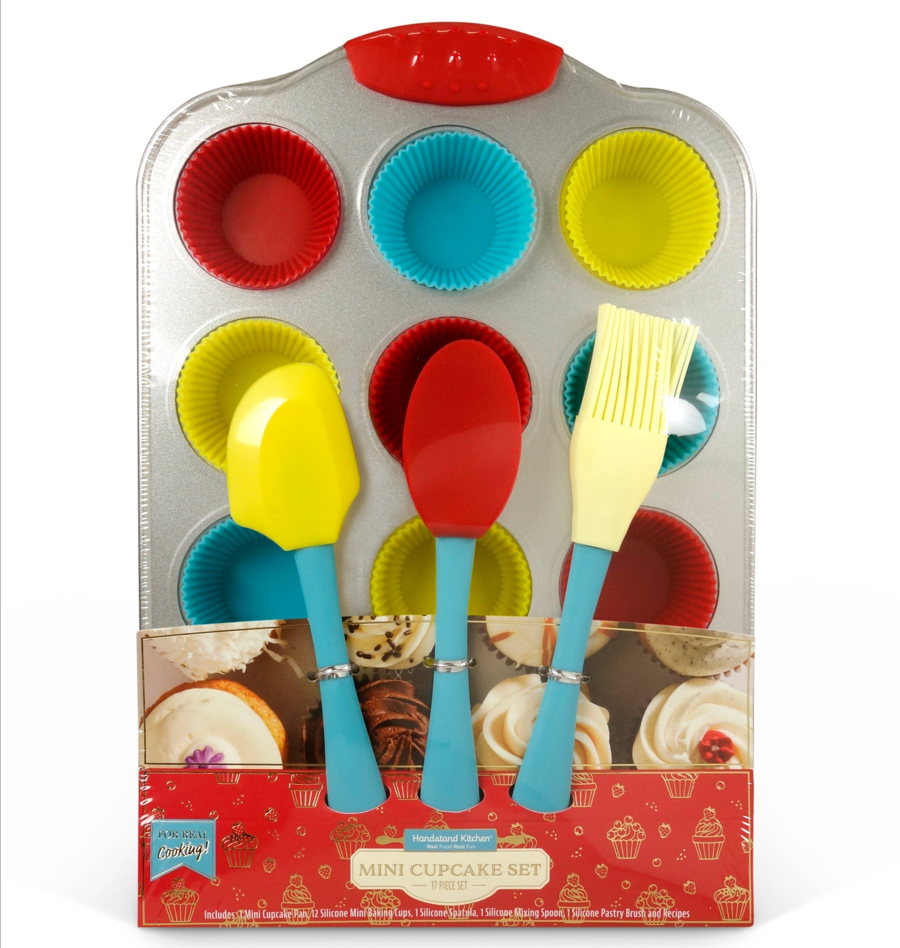 In box image of Mini Cupcake Set which Includes: 1 metal mini cupcake pan with 12 silicone baking cups, 1 silicone spatula, 1 silicone pastry brush, 1 silicone mixing spoon and recipes.