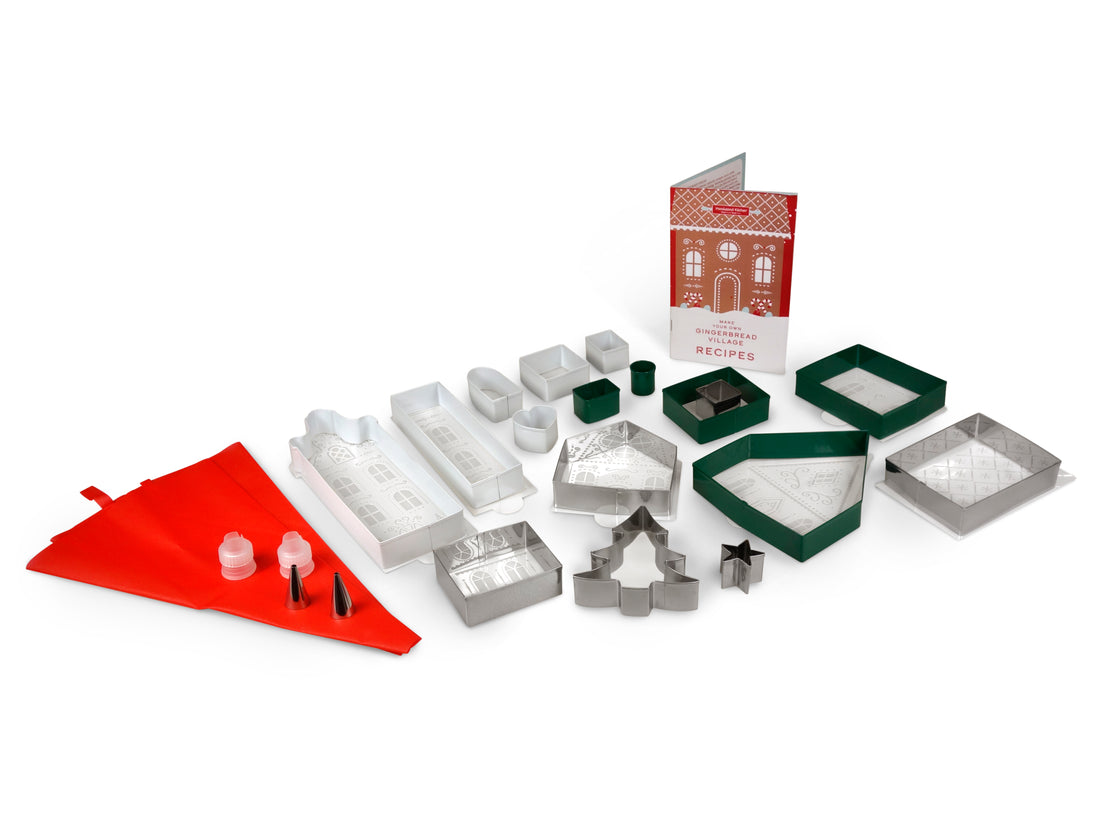 Out of box image of Make Your Own Gingerbread Village including: : 17 Stainless Steel Cookie Cutters to Make  Cottages, Townhouses, Chalets and Gingerbread Men,  7 Decorative Stencils, 1 Frosting Scraper, 2 Reusable  Frosting Bags, 2 Frosting Couplers with Rings and 2  Stainless Steel Frosting Tips, along with Recipes and Instructions