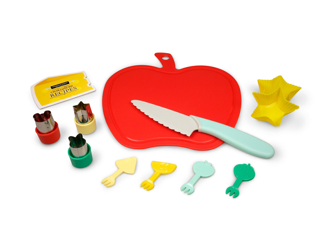 Out of box image of Foodie Friends CHARcuteRIE Set containing : 1 apple cutting board, 1 child-safe serrated knife, 2 silicone  snack cups, 3 fruit/vegetable cutters, 8 fruit/vegetable picks and recipes.
