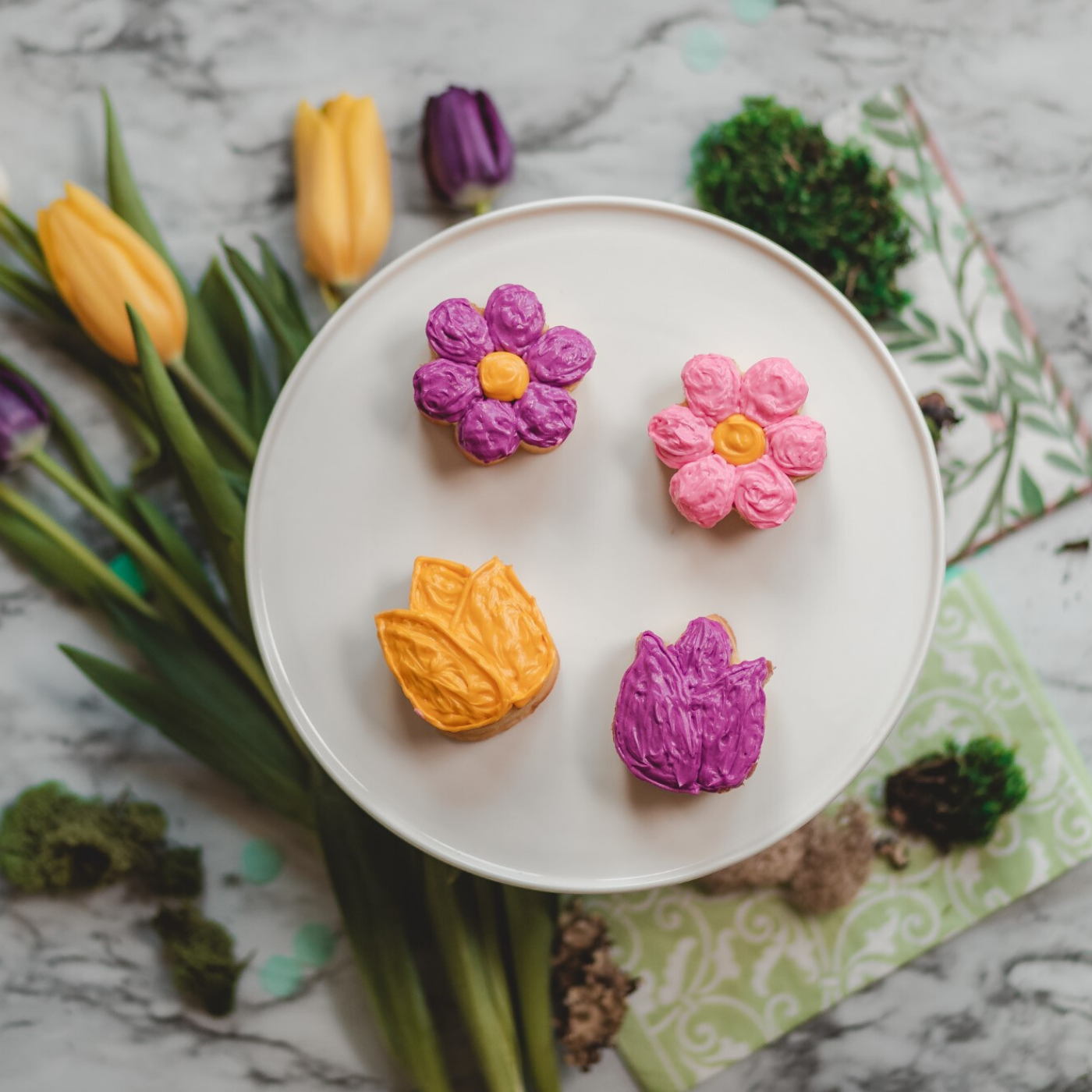 Lifestyle image of cupcakes decorated as flowers. 