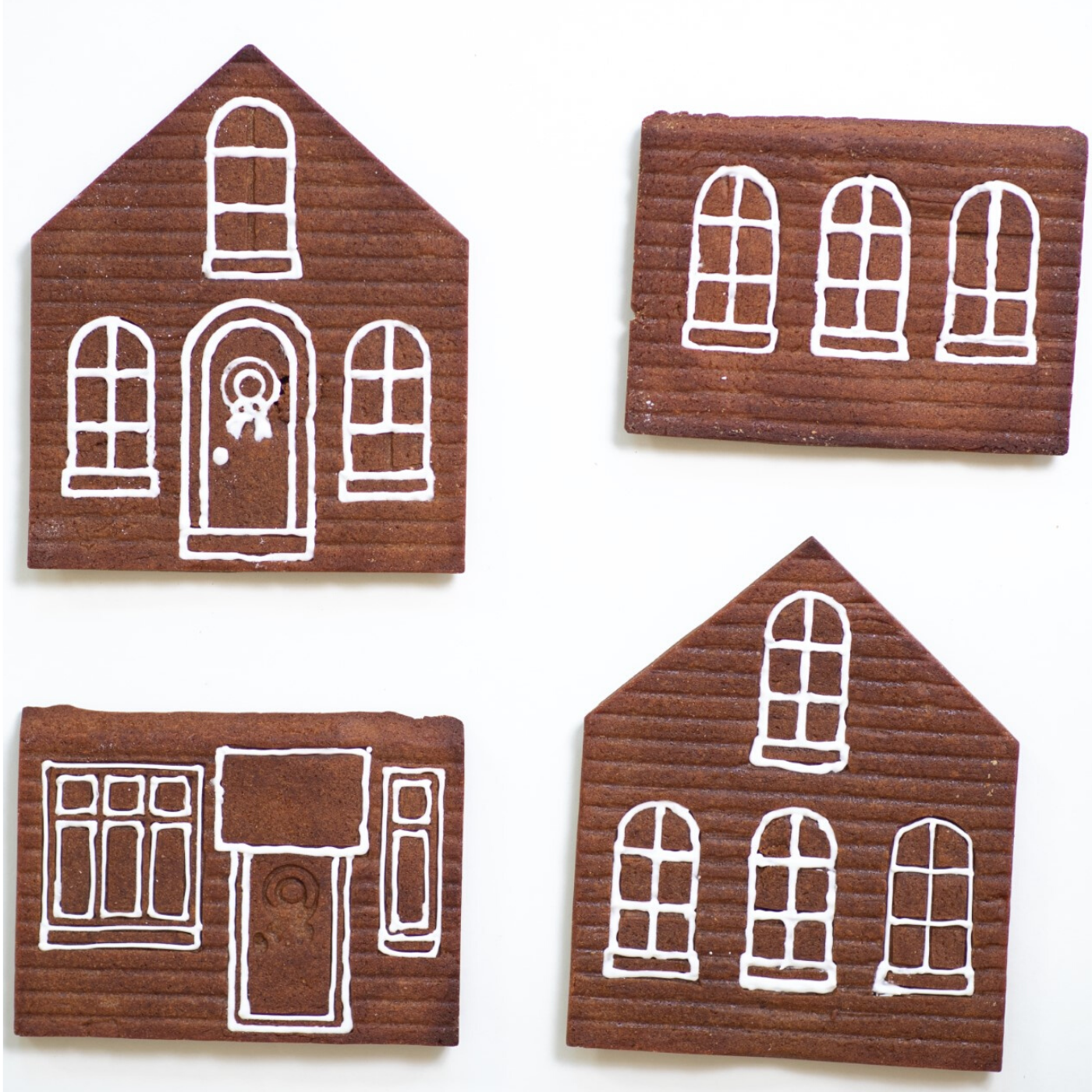 image of the 4 sides of the gingerbread house with windows and doors outlined in white icing