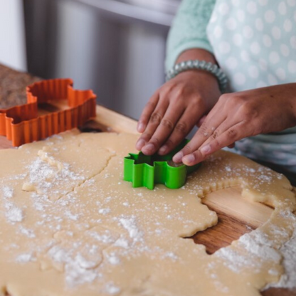 Lifestyle photo of child cutting cactus shaped cookie using Llama Love &amp; Cactus Stainless Steel Cookie Cutters