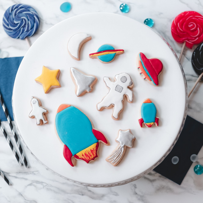 Lifestyle image of decorated out of this world cookies including astronuats and space ships 