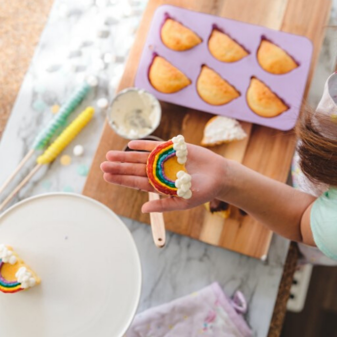 Lifestyle image of Rainbow Shaped Cupcake Silicone Baking Mold being used to bake cupcakes.