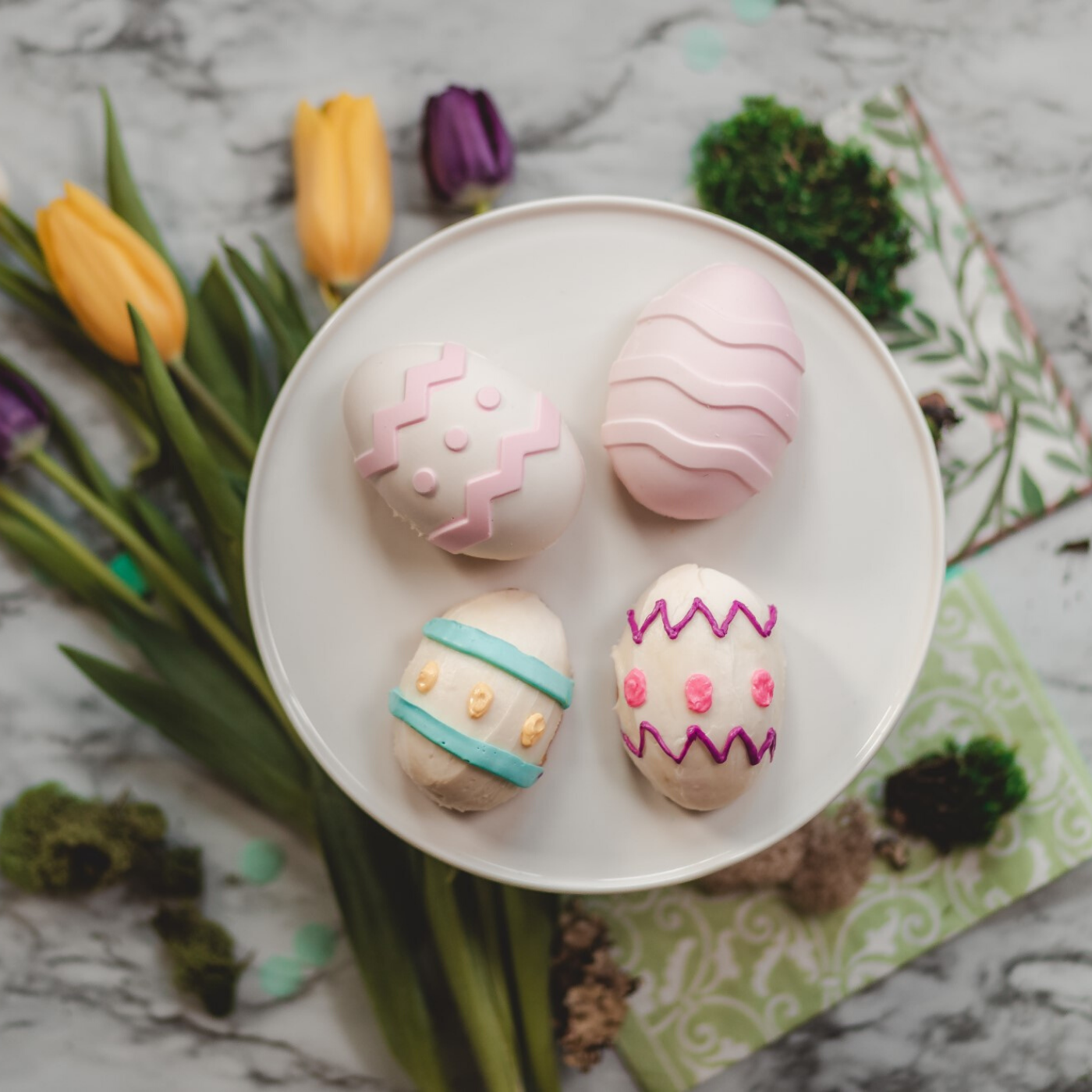 Lifestyle image of 4 decorated spring fling egg cupcakes 