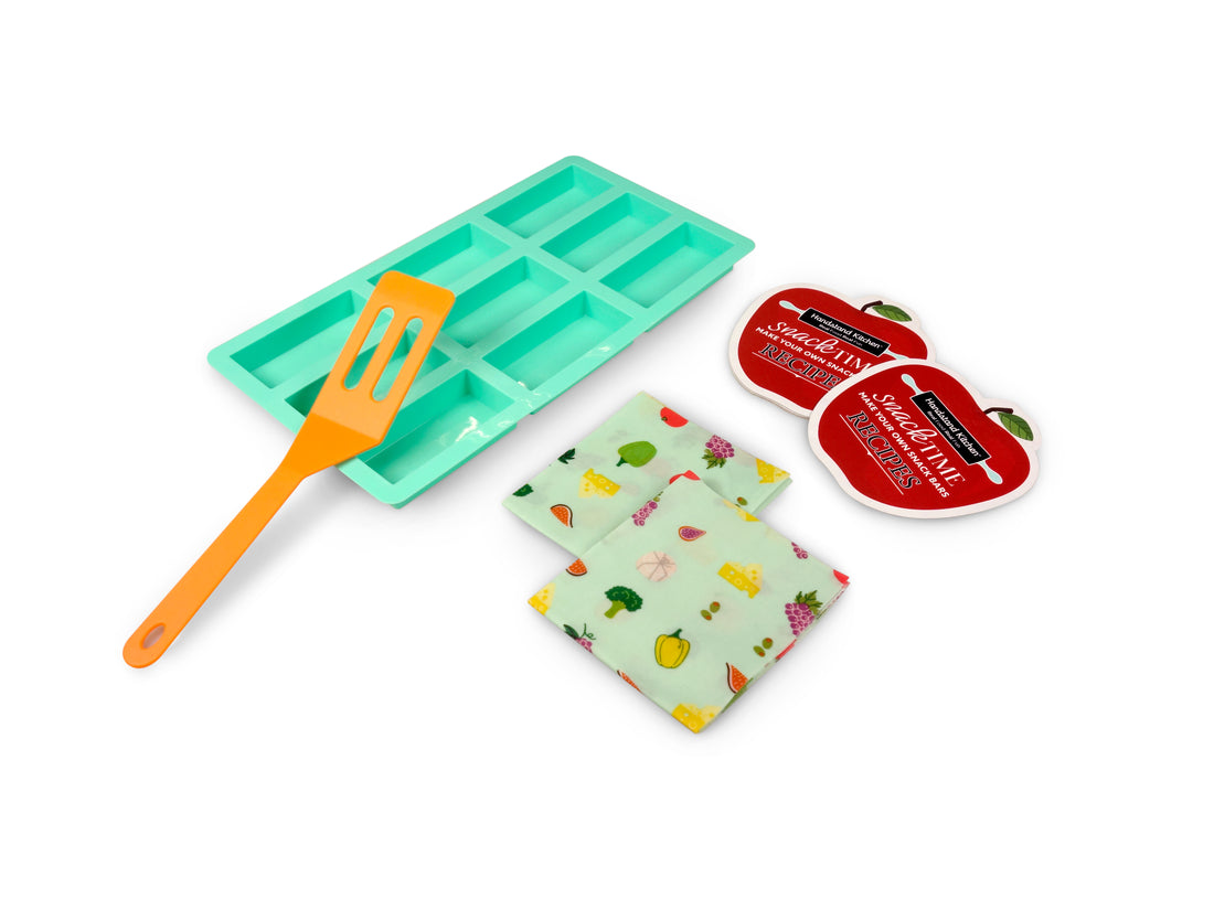 Out of box image of Snack Time Make Your Own Snack Bars including 1 Silicone Snack Mold, 1 Spatula, 2 Reusable Beeswax Wraps and Recipes