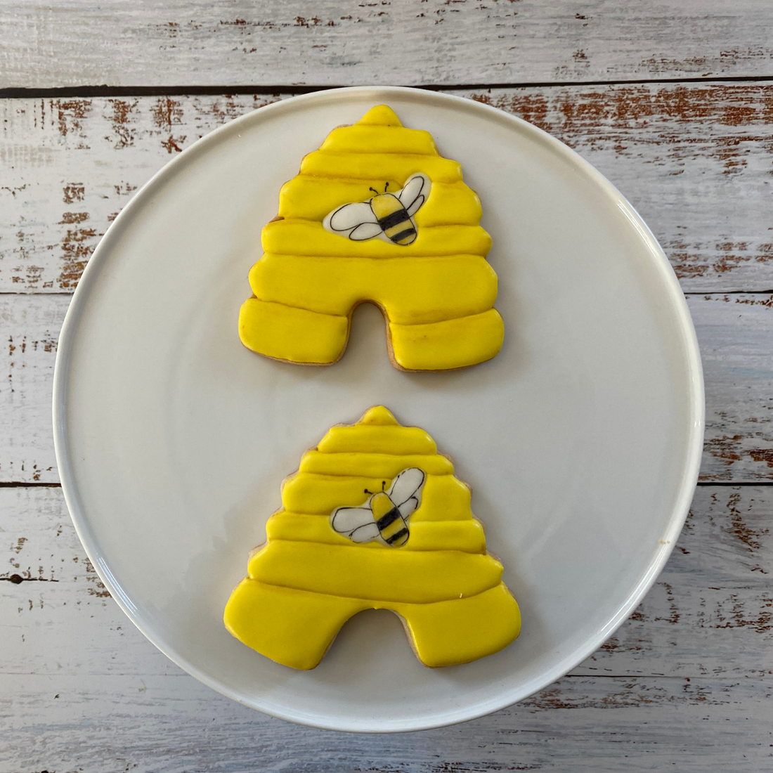 Lifestyle image of two bee hive shaped cookies 