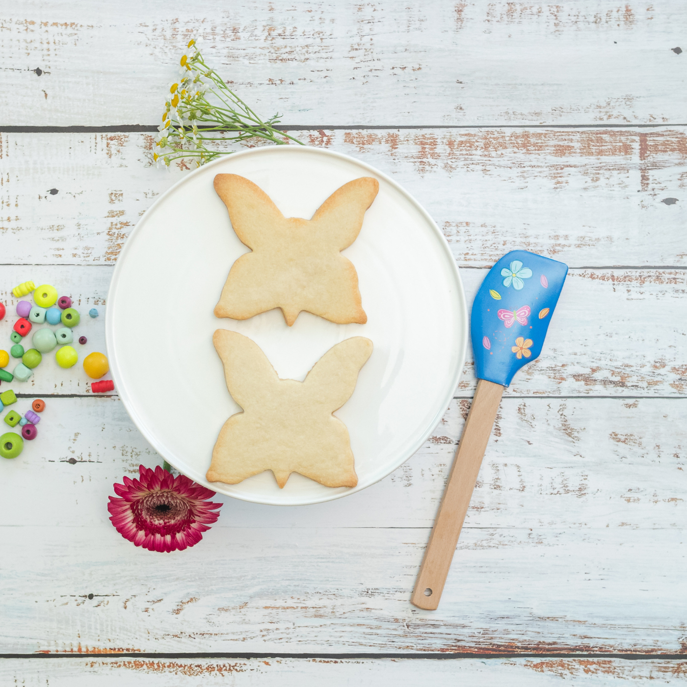 Lifestyle image of two butterfly shaped cookies 