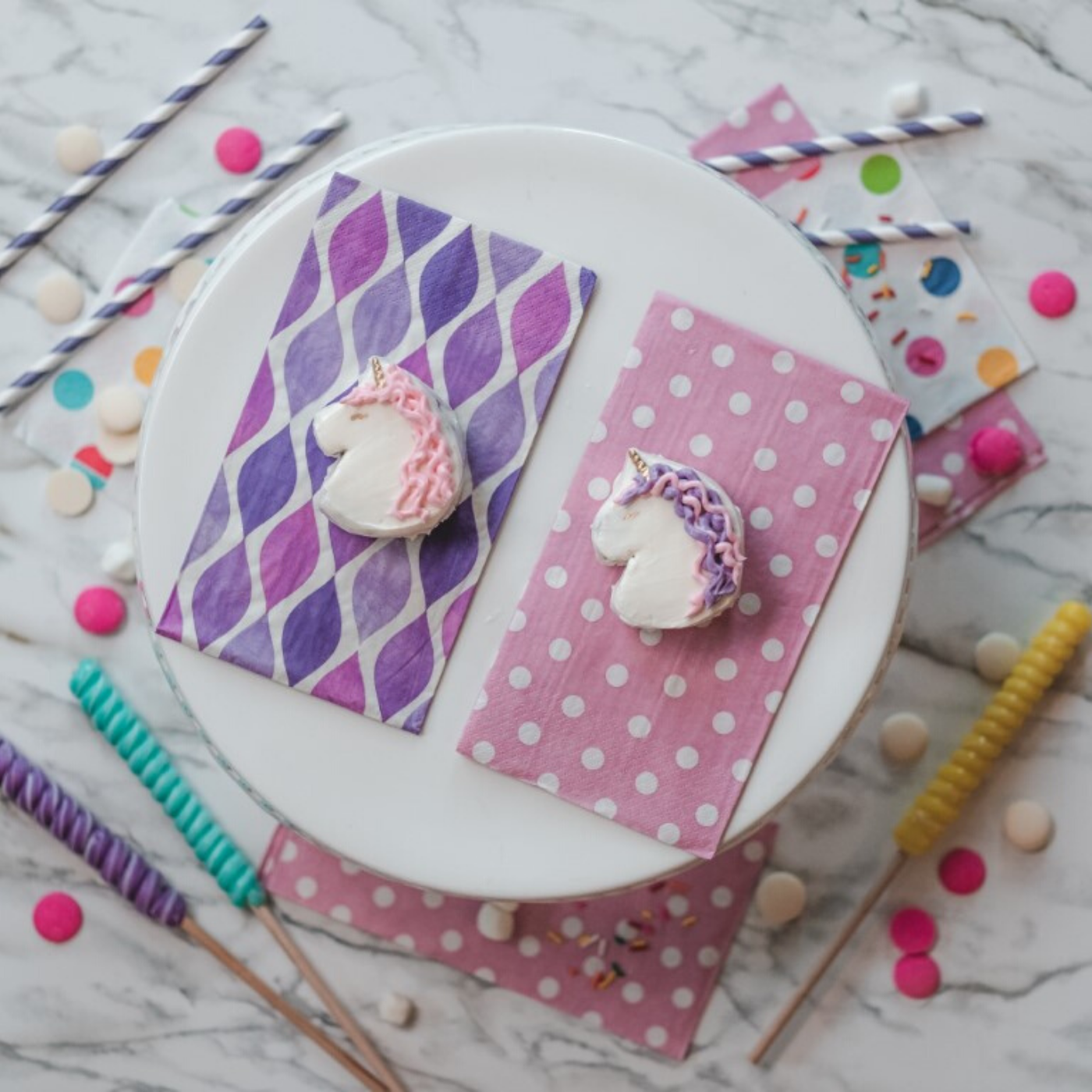 Lifestyle image of two unicorn cookies