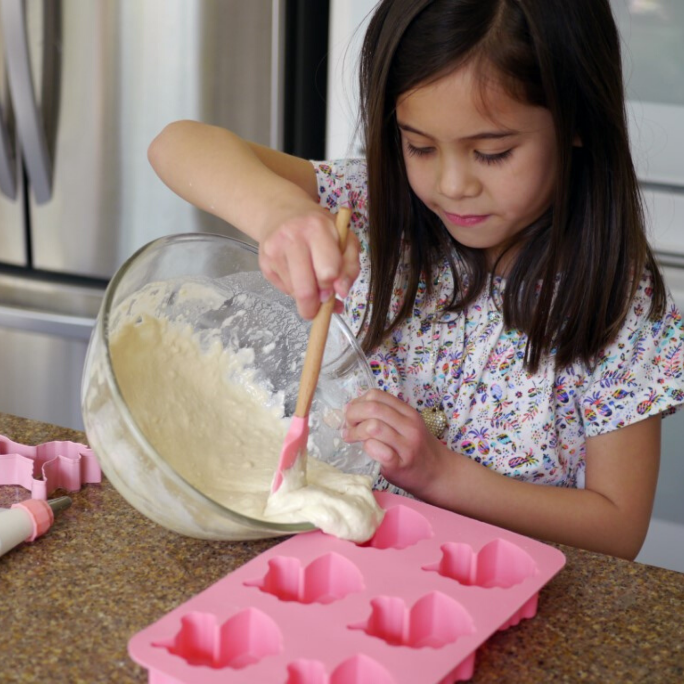 Lifestyle image of girl using the unicorn cupcake mold