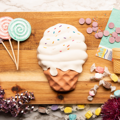 Lifestyle photo of Ice cream cone shaped cake decorated with icing and sprinkles made using the Ice Cream Parlor Large Cake Making Set