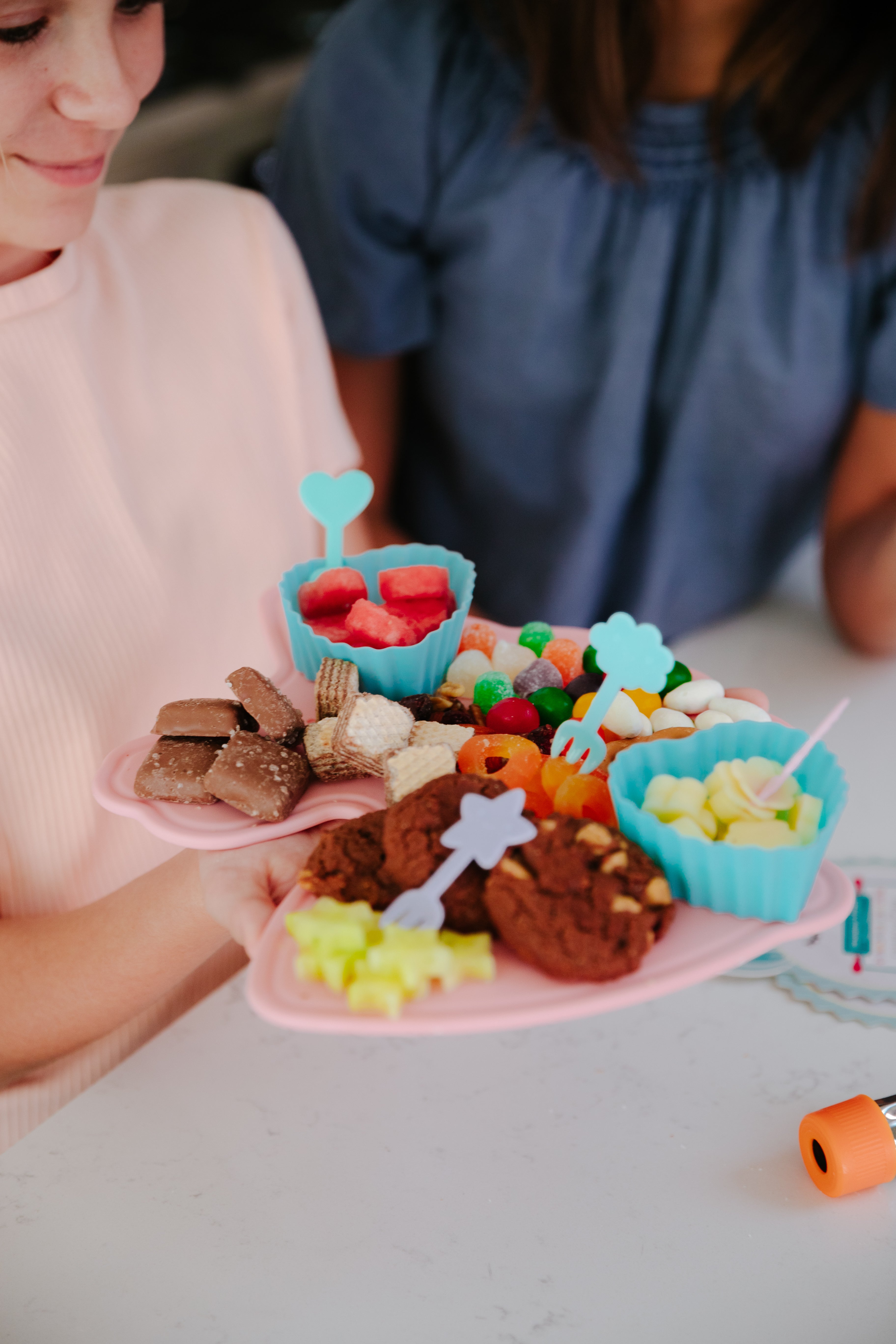 Lifestyle image of a decorated rainbows and unicorns charcuterie set with various fruits and vegetables 