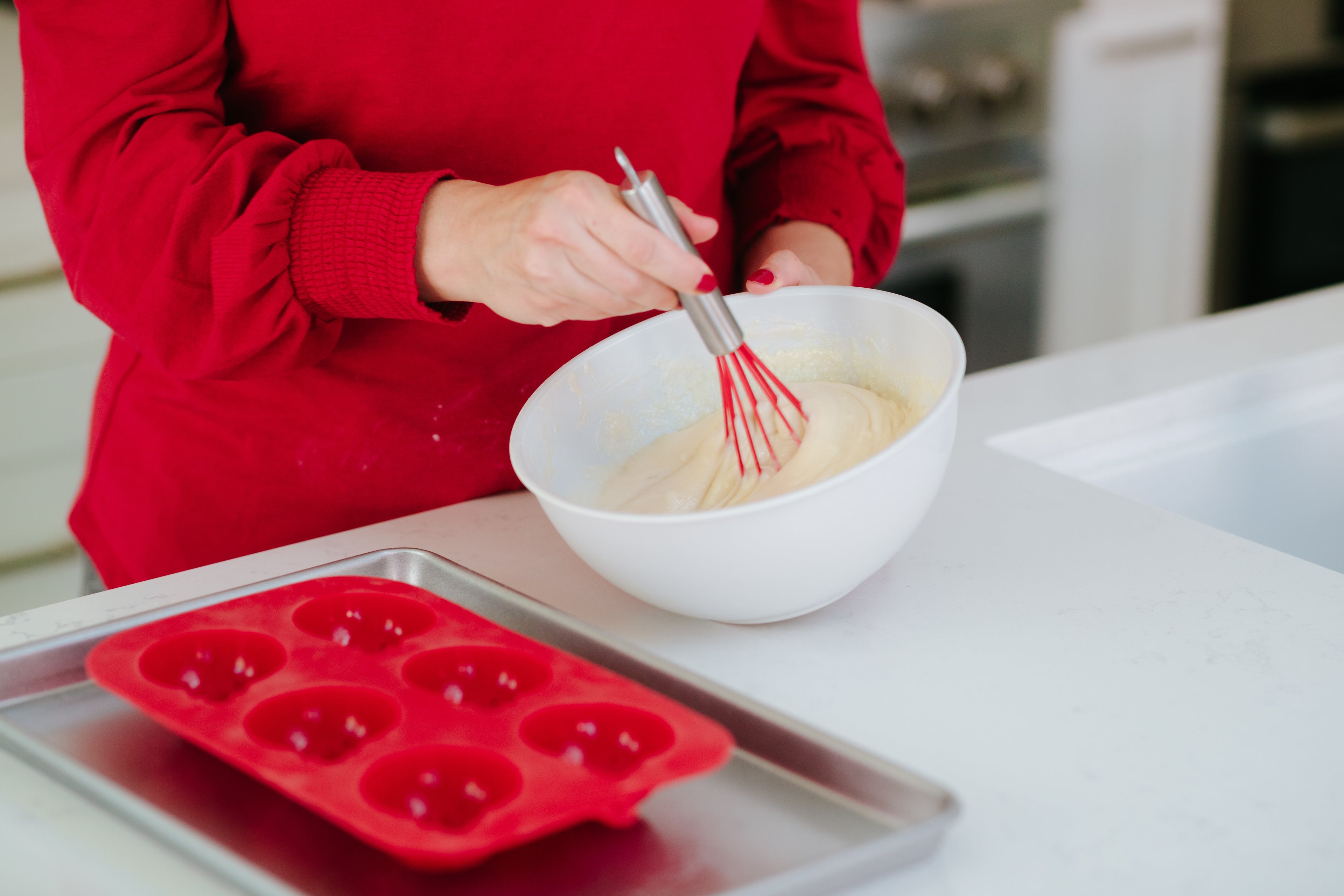 Lifestyle image of a person using the ornament mold to bake cupcakes 