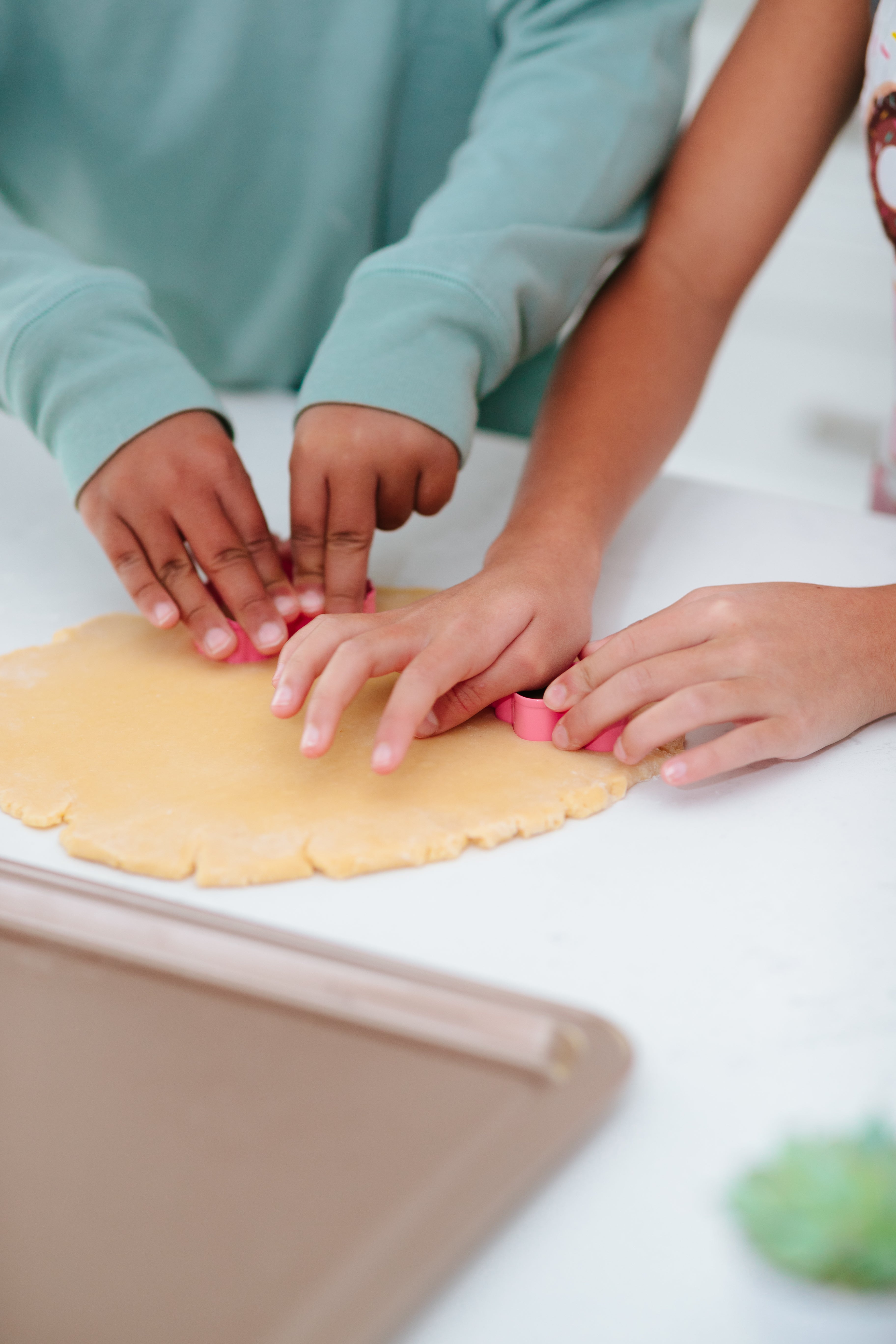 Lifestyle image of people cutting out heart shaped cookies