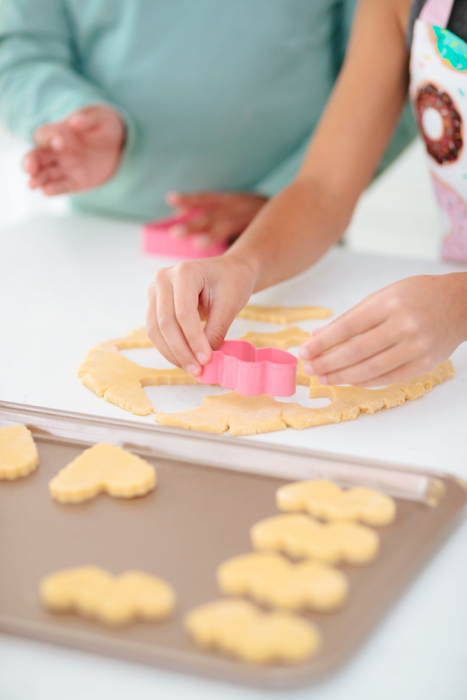 Lifestyle image of people cutting out heart shaped cookies