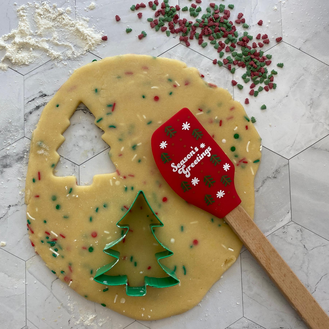 Image of Winter Wonderland Tree Cookie Cutter Set with Spatula being used to bake tree shaped cookies 